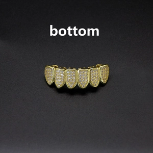 Macro detail of bottom row gold plated hip hop grillz with micro-pave zircon stones