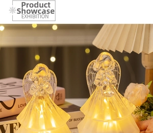 Detailed close-up of LED glowing plastic crystal angel statues with warm yellow light