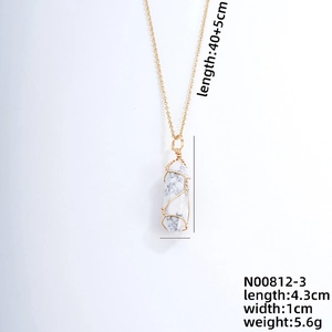 Detail view of hexagonal white stone pendant with gold wire wrapping and dimensions