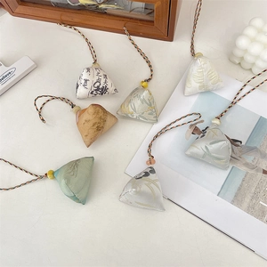 Close-up of silk zongzi charms with colorful woven cords and traditional tassels