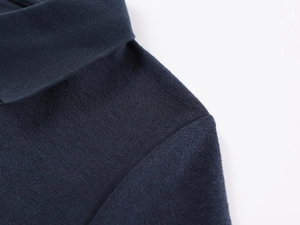 Macro shot of navy blue polo shirt collar showing premium knit texture and stitching