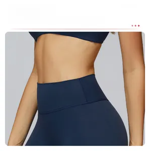 Detail of high waisted yoga shorts showing tummy control fit and smooth navy blue fabric