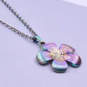 Macro detail of rainbow plated five-petal flower pendant on a stainless steel chain