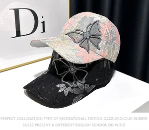 Detail of lace baseball caps with rhinestone butterfly and floral embellishments