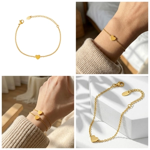 Detail of 18k gold plated heart charm bracelet with adjustable chain and K18 tag