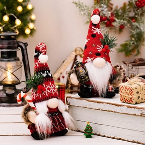 Christmas faceless gnome dolls with red knit hats and candy cane in holiday setting