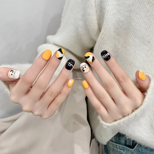 Detailed view of handmade short press-on nails with cute cat and fish bone patterns