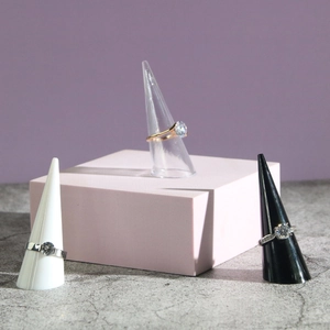 Elegant gold and silver rings with round crystals on pyramid display stands
