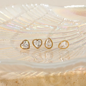 Minimalist gold stainless steel stud earrings set with heart and teardrop zircon crystals