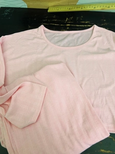 Detail of pink knitted loungewear set featuring vertical ribbing and pointelle hollow pattern