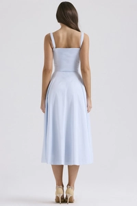 Back view of light blue backless midi dress showing minimalist A-line cut and sleek fabric