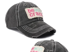 Close-up of distressed cotton baseball cap with beach crazy patch and white contrast stitching