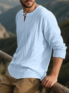 Detail of light blue linen shirt featuring vertical pleated texture and long sleeves