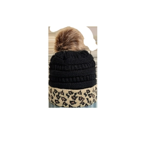 Winter knitted beanie featuring leopard print cuff and a faux fur pom-pom on top
