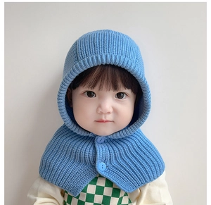 Close-up of blue knitted infant hooded scarf with wood buttons on soft knit texture