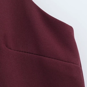 Close-up of wine red plain weave fabric showing detailed texture and seam craftsmanship