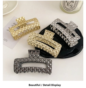 Detailed macro view of quilted pattern hair claws in gold, silver, and champagne metal finish