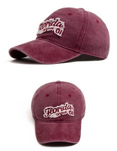 Detail view of burgundy washed cotton baseball cap with Florida embroidery and vintage finish