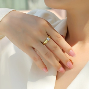 Close-up of gold S925 silver ring featuring a square-cut moissanite stone on finger