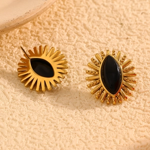 Macro shot of 18K gold plated stainless steel sunburst earrings with black onyx inlay
