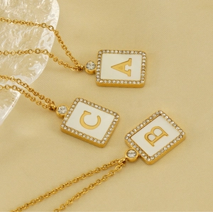 Detailed view of three gold square letter pendants A, B, and C with rhinestone edges