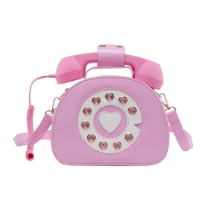 Close-up of pink vintage telephone handbag with heart dial and spiral cable detail