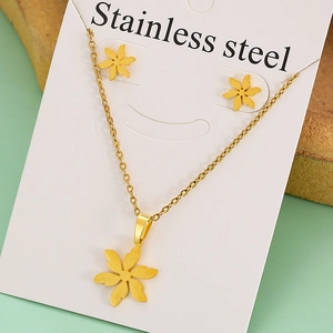Detailed view of golden stainless steel flower pendant necklace and earring set on card