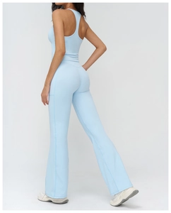 Detail of high-waist flare yoga pants and racerback top in light blue athletic fabric