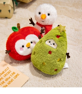 Macro shot of plush Christmas toys including reindeer, apple and tree with embroidery