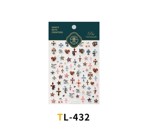 Detail view of Y2K nail art stickers featuring gothic crosses, leopard hearts and stars