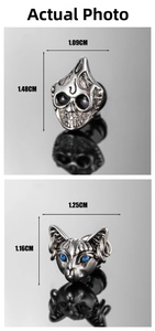 Detailed macro view of punk style cat head pendant and skull charm with blue stone eyes