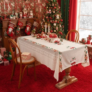 Rectangular Christmas tablecloth with festive embroidery in a cozy living room setting