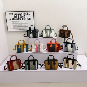 Fashionable striped canvas crossbody handbags in multiple colors with leather handles
