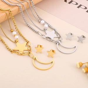 Flat lay of gold and silver layered necklaces with star moon pendants and pearl details