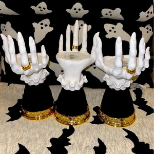Detailed view of resin witch hand trays with gold rings and gothic base ornaments