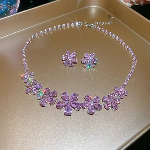 Detailed view of silver flower jewelry set with pink zircon petals and starburst shine