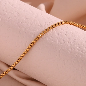 Macro shot of an 18K gold plated box chain showing detailed square links and texture