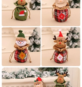 Detail of Christmas drawstring gift bags featuring festive snowman and reindeer designs