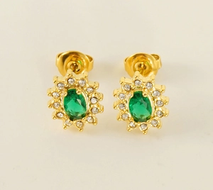 Detailed macro view of golden sunflower earrings with oval green zircon and crystal halo