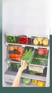 Close-up of transparent drawer storage box hanging under a refrigerator shelf