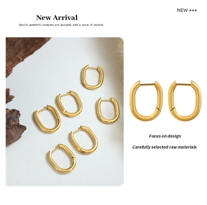 Macro shot of 18K gold plated U-shaped earrings with a polished mirror finish