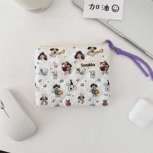Quilted floral makeup bag with dog patterns on office desk near laptop and earphone