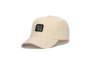 Detailed view of beige cotton baseball cap featuring embroidered MARIA rectangular patch