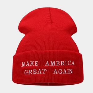 Detailed knit texture and white embroidery on a red Make America Great Again beanie hat