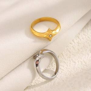 18K gold and silver stainless steel star rings with zircons on velvet surface