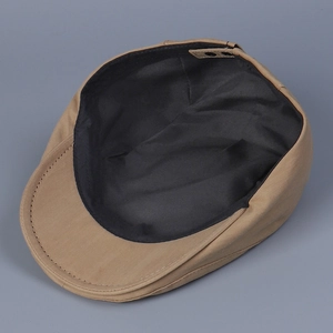Detail view of khaki newsboy cap featuring black inner lining and adjustable back strap