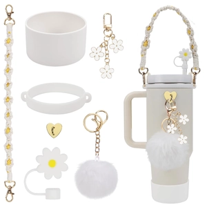 Beige tumbler accessory set with daisy straw cover, woven strap, and silicone boot
