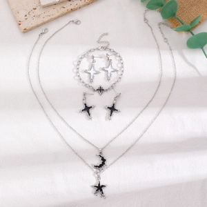 Detailed set of silver layered necklaces with black moon stars and cross earrings