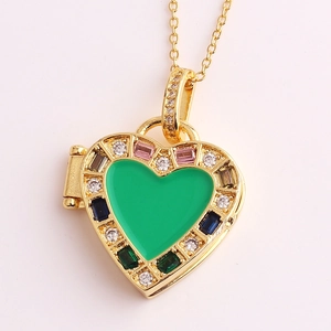 Detailed close-up of a golden heart locket necklace with green enamel and colored zircons