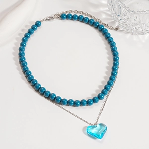 Double layer necklace with blue resin beads and a blue heart glass pendant on silver chain